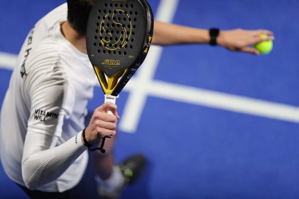 Proper way to apply an overgrip on a padel racket for better grip control.